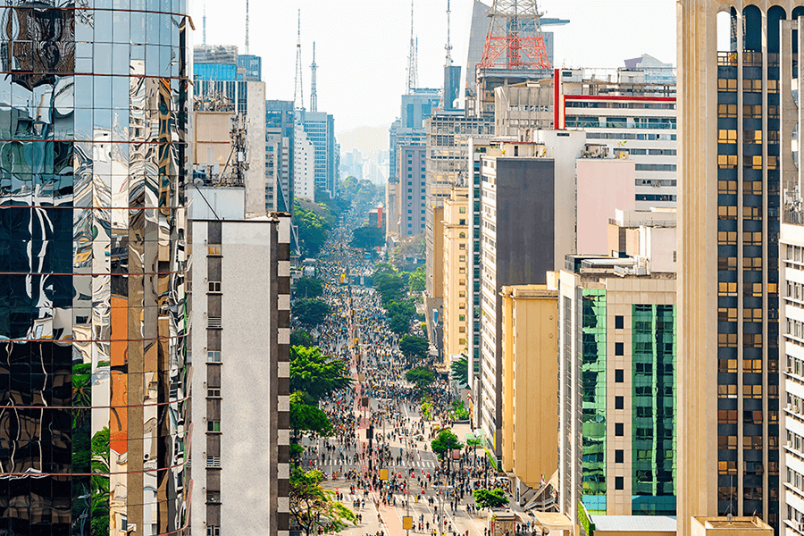 Aerial view of Paulista avenue full of people walking on the street and the tall buildings of the avenue. Commercial center at downtown of Sao Paulo SP, Brazil