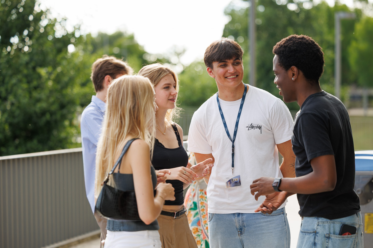 Students chatting outside in a group