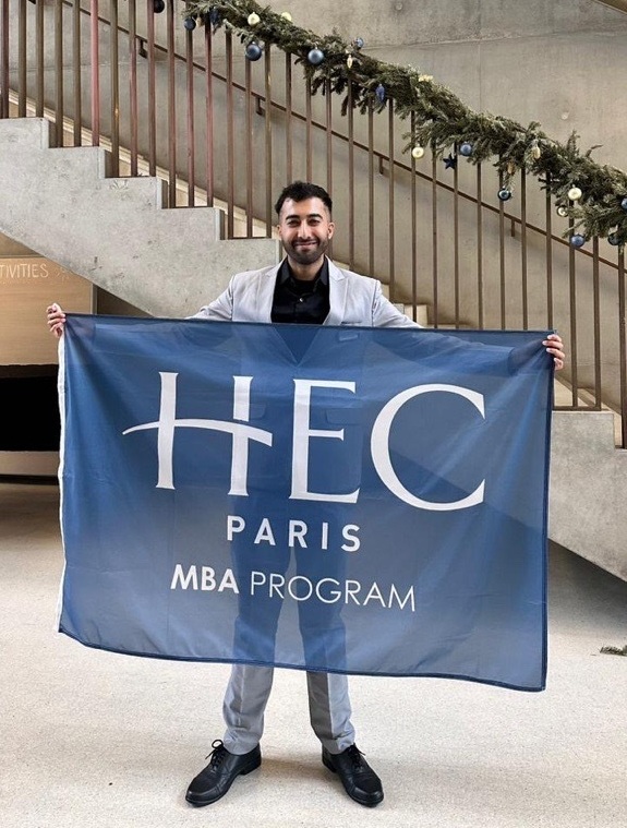 MBA participant Harivansh Gahlot holding the MBA flag in the S buillding
