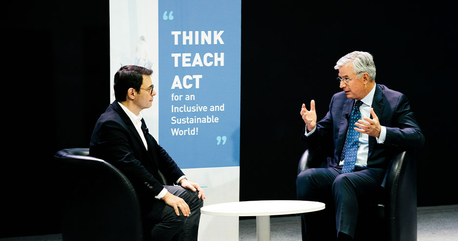 Rodolphe Durand and Hubert Joly in conversation, seated on stage
