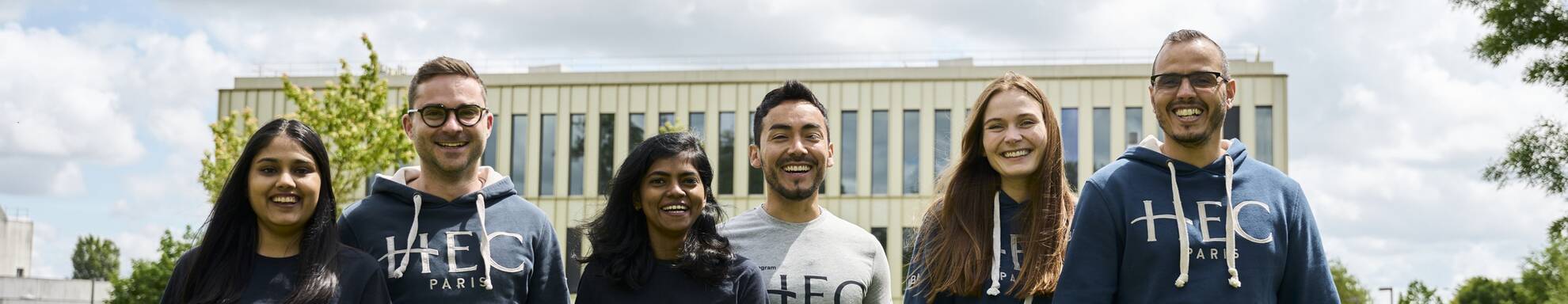 MBA students in hoodies and T-shirts walking on campus