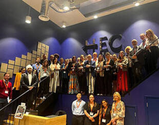 A large group of people are standing on a staircase, posing for a picture