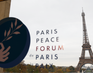Logo of the Paris Peace Forum with a view of the Eiffel Tower through a window, symbolizing international cooperation and commitment to peace.
