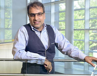 Dr. Tayyab Rashid, expert in Positive Clinical Psychology and Faculty Affiliate at Harvard, pictured indoors on a university campus