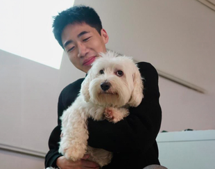 man with a dog in the classroom