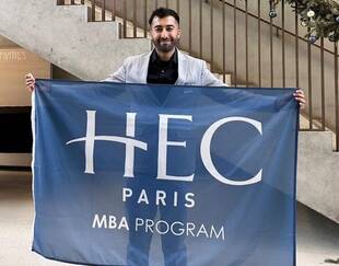 MBA participant Harivansh Gahlot holding the MBA flag in the S buillding